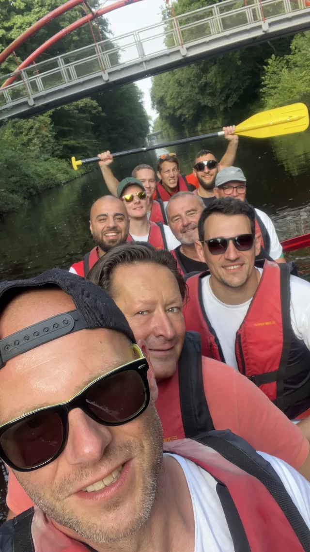 Selfie einer Gruppe im Kanu unter einer Brücke